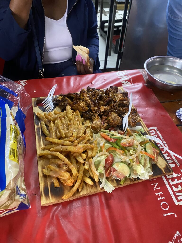Chubby Cheeks Eatery serving food on a wooden board, meat, chips and salad